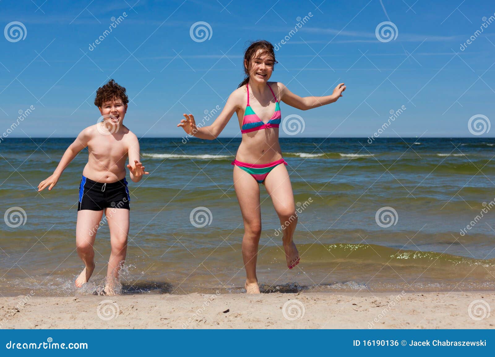 Kids running on beach stock photo. Image of jumping, enjoyment
