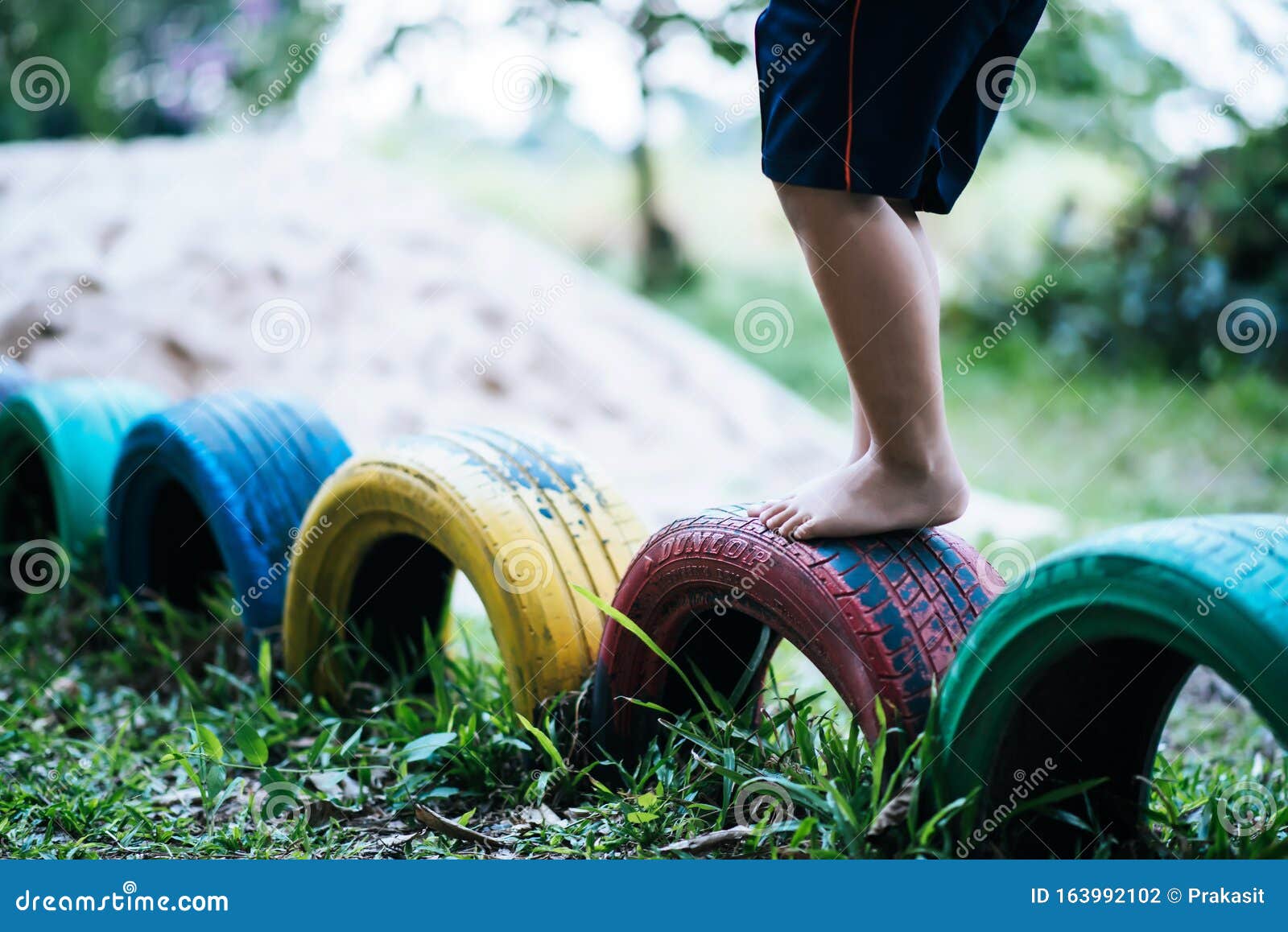 Kids running on tires stock photo. Image of backyard 163992102