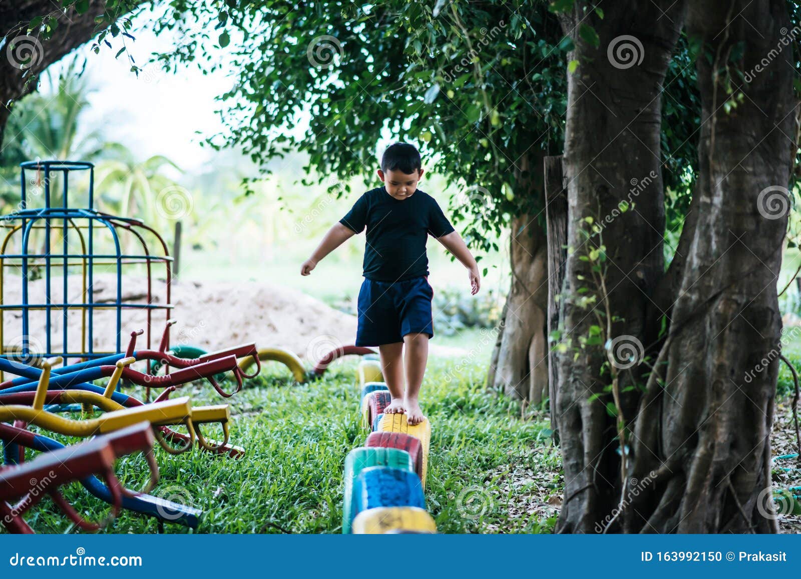Kids running on tires stock photo. Image of tires, grass 163992150