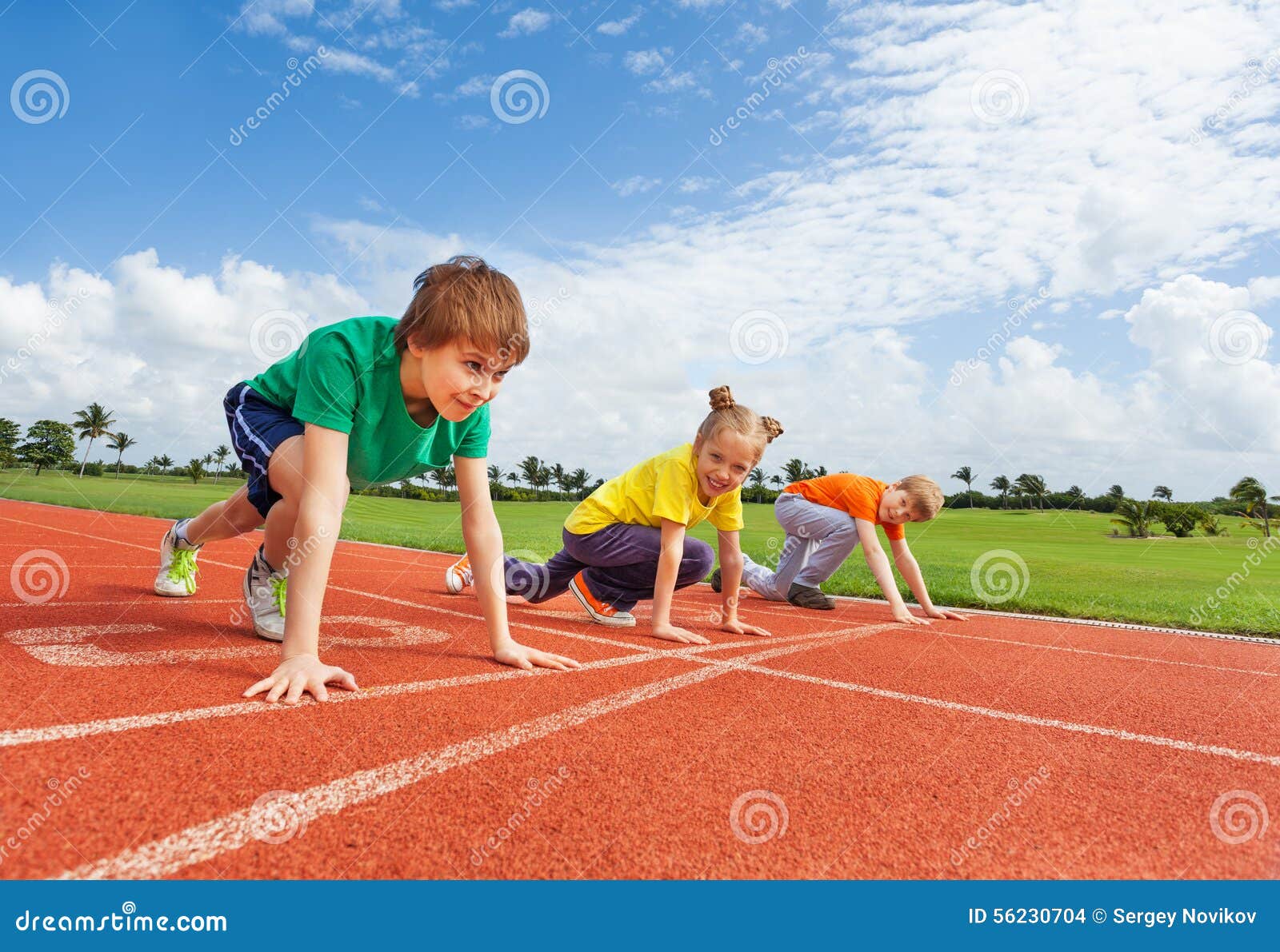 kids in uniforms on bended knee ready to run