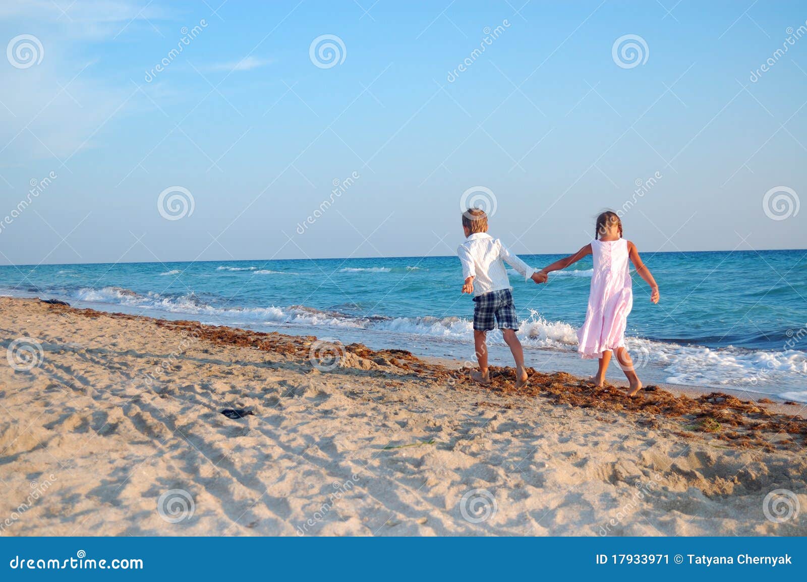 kids walking along the beach together
