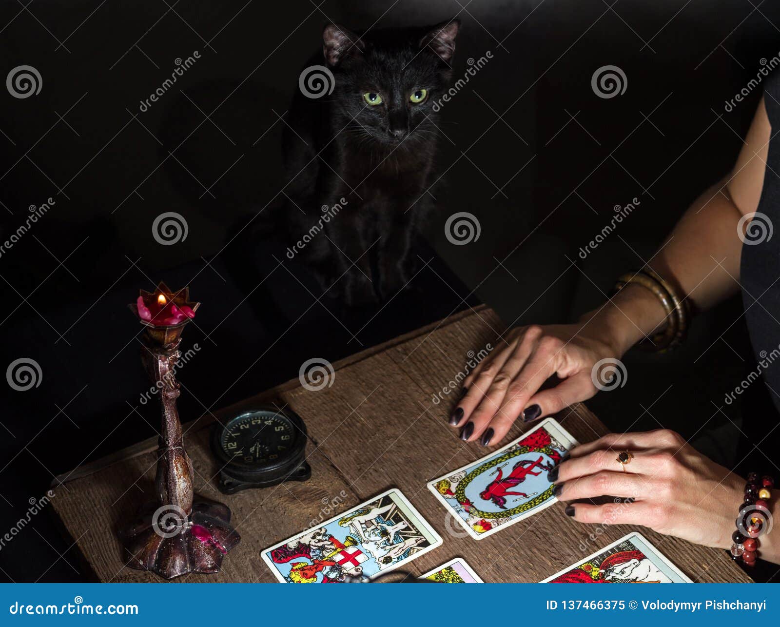 The Fortune Teller Lays Out On A Wooden Table The Tarot Cards By The Light Of A Lantern And A ...