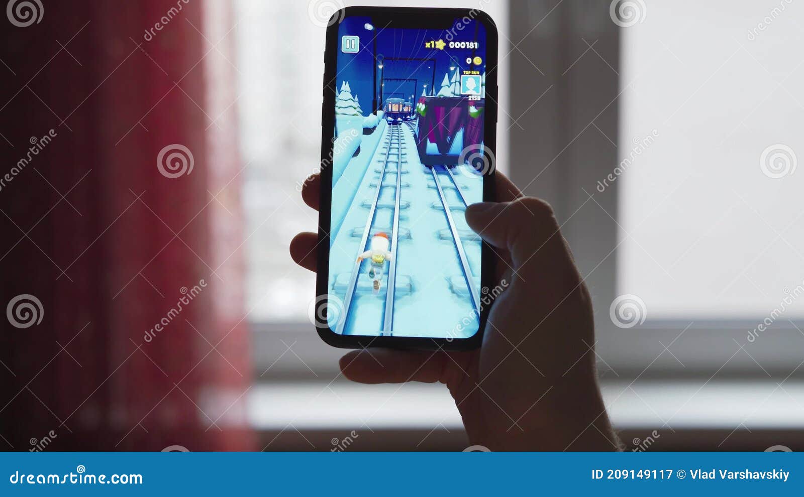 LVIV, UKRAINE - November 08, 2022 : Playing mobile game Subway Surfers on  modern smartphone. Stock Photo