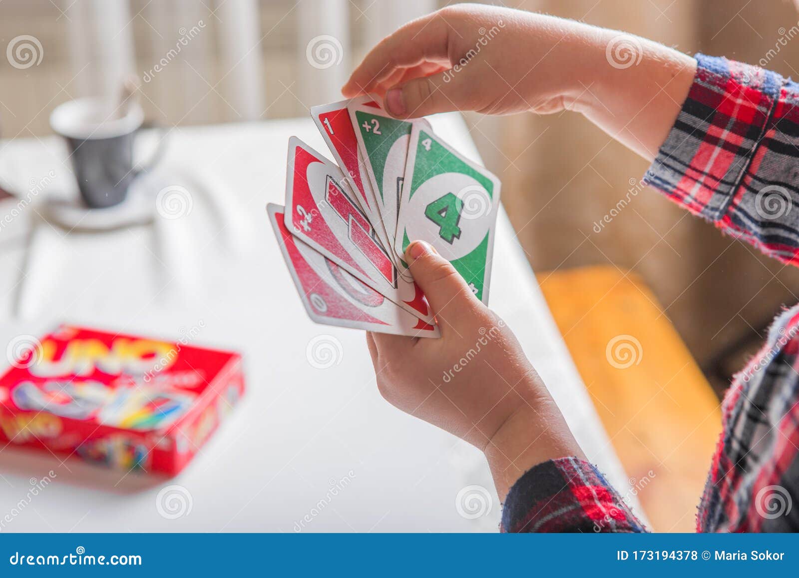 Uno cards in hand, card game Stock Photo by ©Egor_1896 239236398