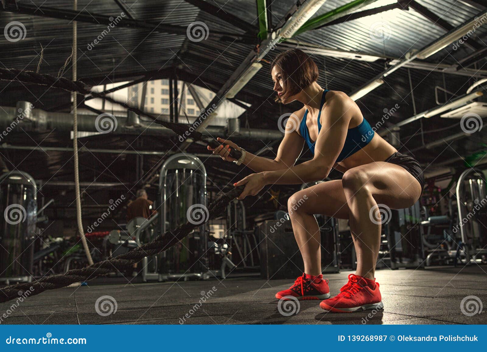 Beautiful Strong Sporty Woman Doing Crossfit Exercise With Battle Ropes