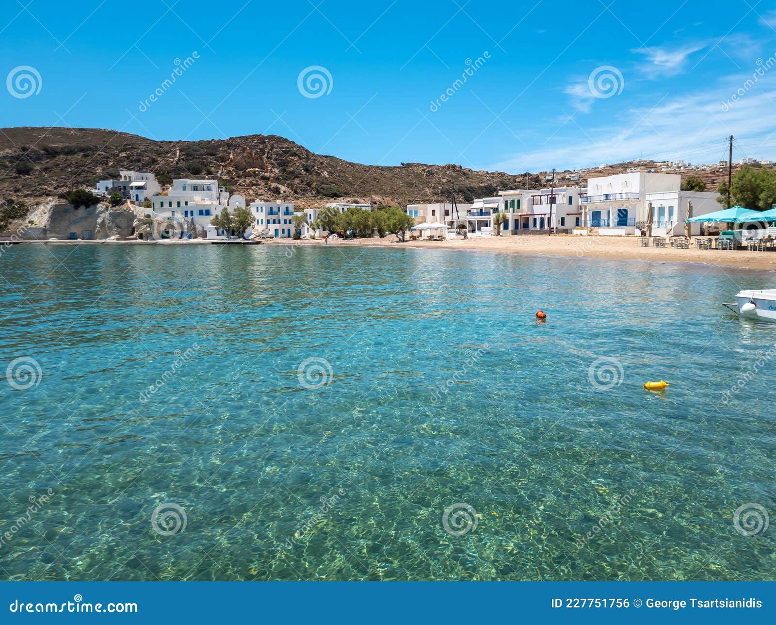 kimolos island psathi port cyclades greece. shops cafe at seaside buildings blue sea