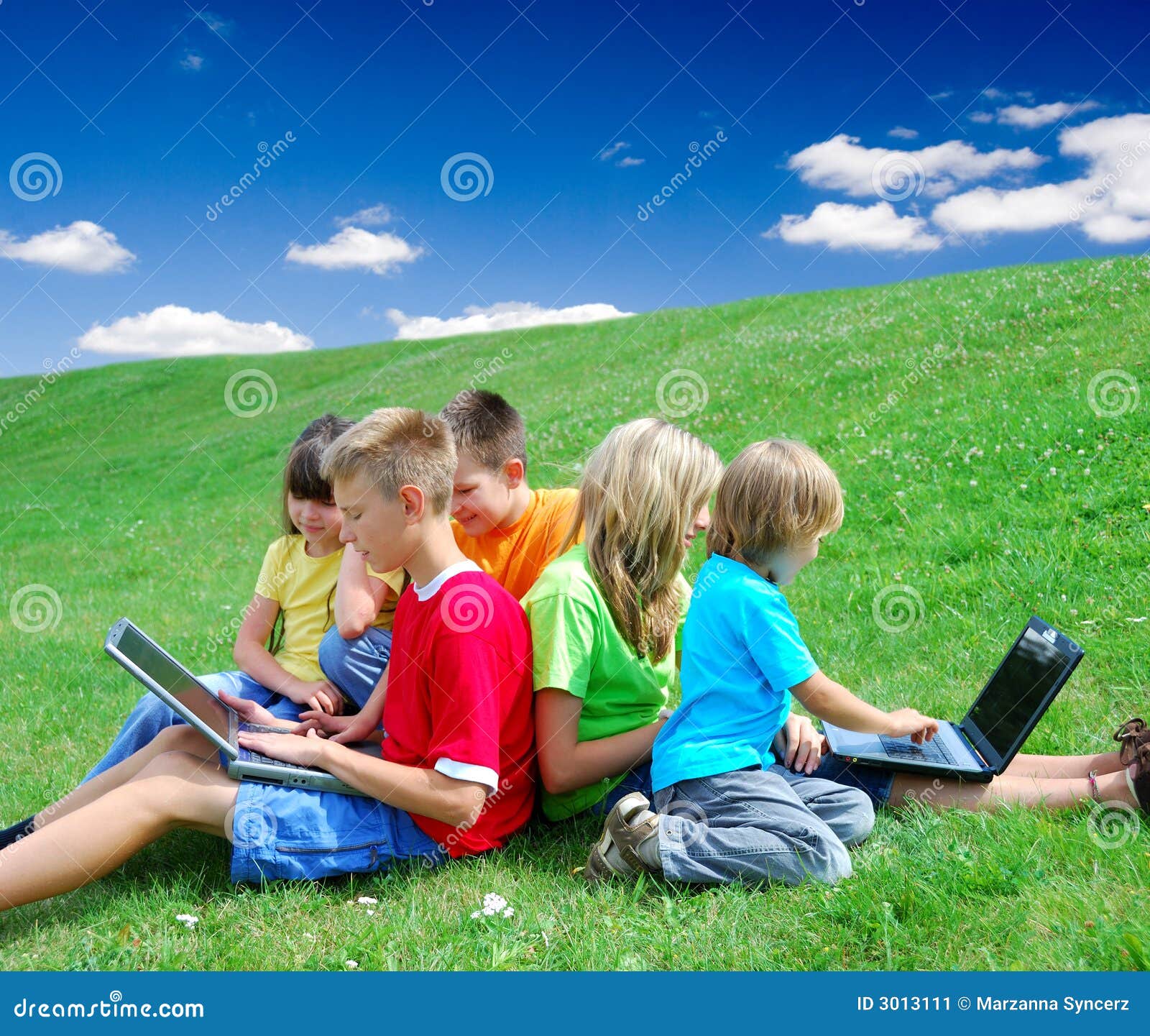 Kinder mit Laptopen auf einem Gebiet.