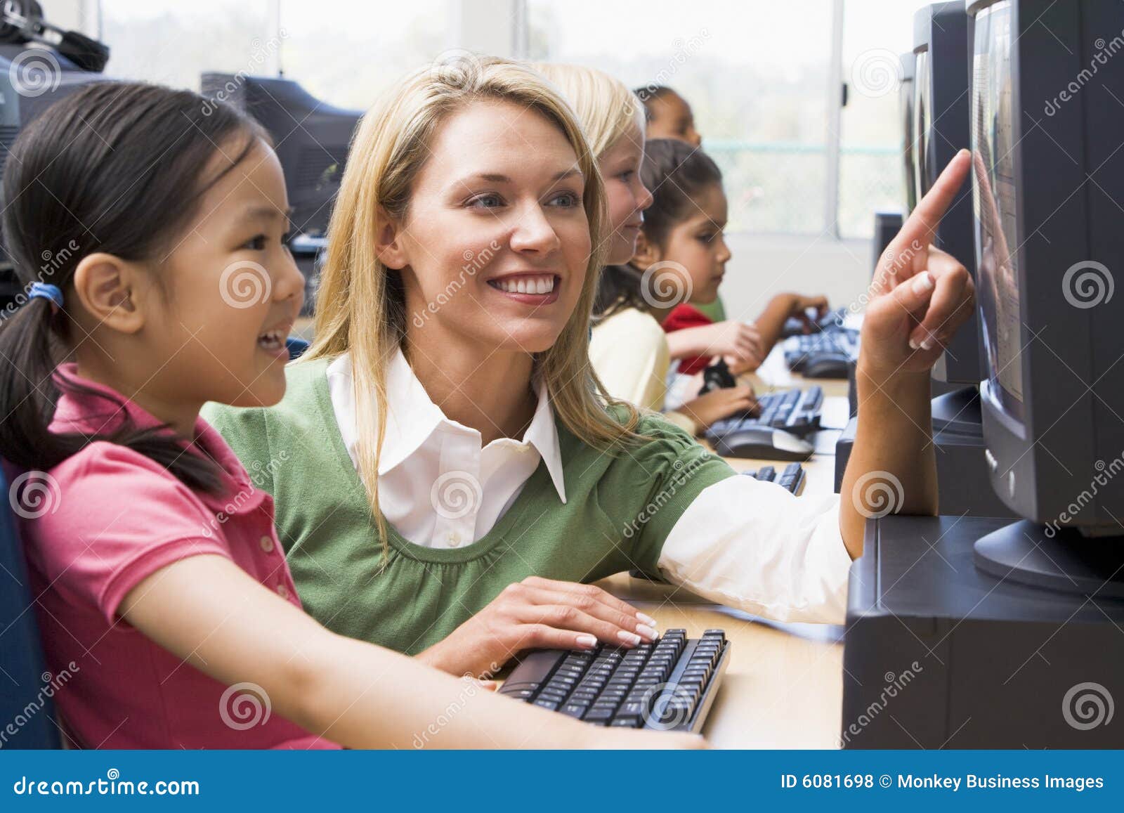 Kindergarten Children Learn To Use Computers Stock Photo