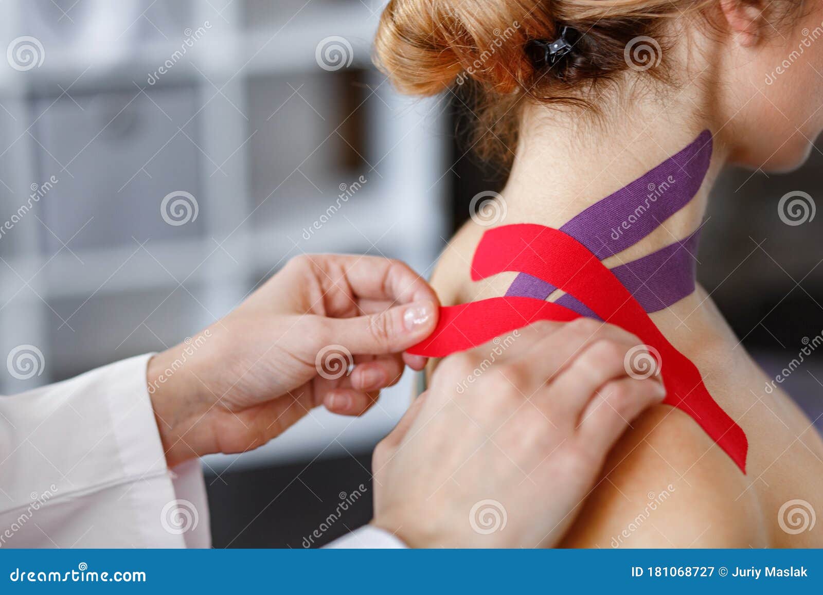 kinesiology taping. physical therapist applying kinesiology tape to patient neck. therapist treating injured trapezius