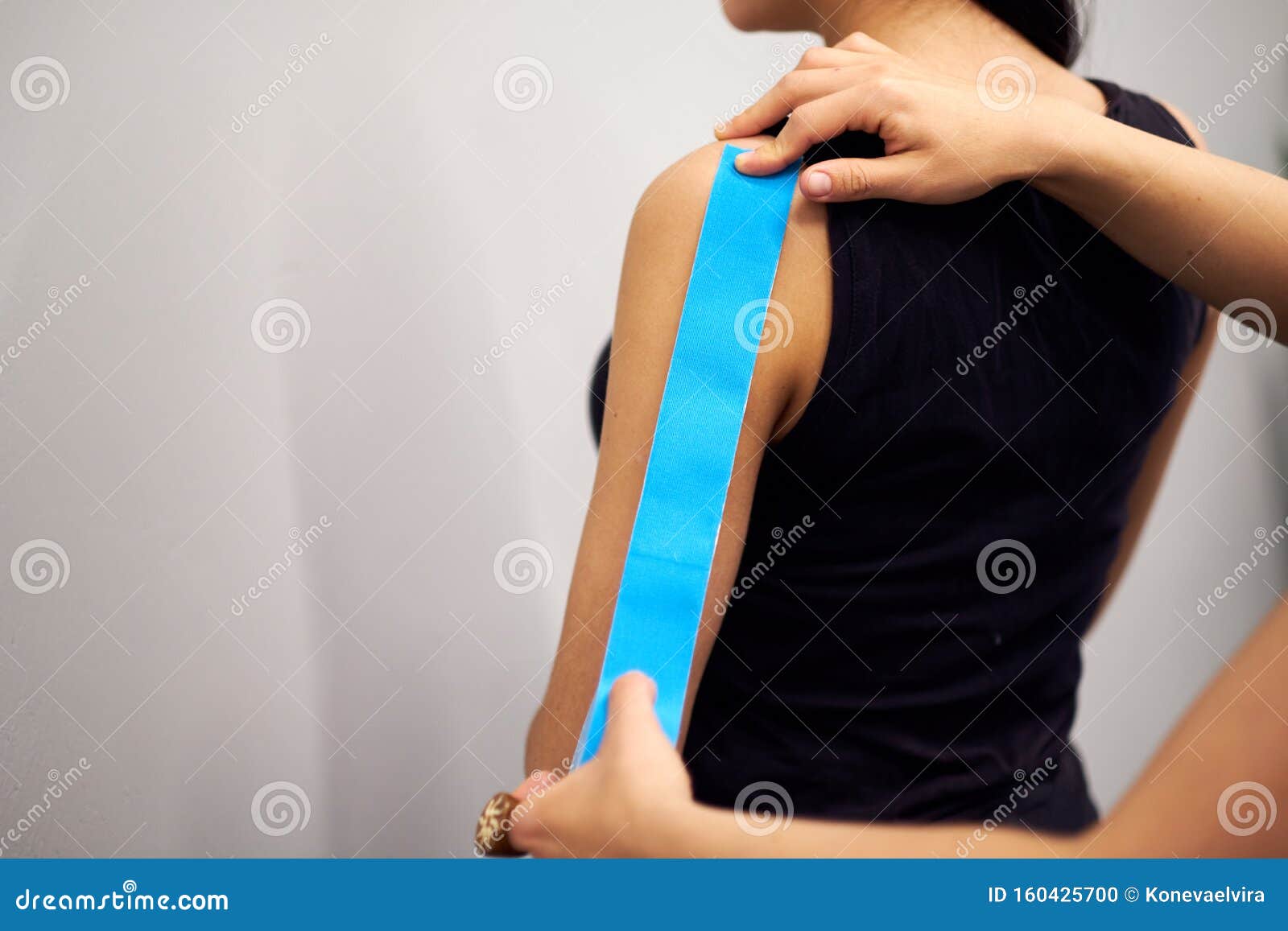 Kinesiology Taping Treatment with Blue Tape on Female Patient Injured Arm. Sports Injury Kinesio Treatment Stock Photo - Image of 160425700