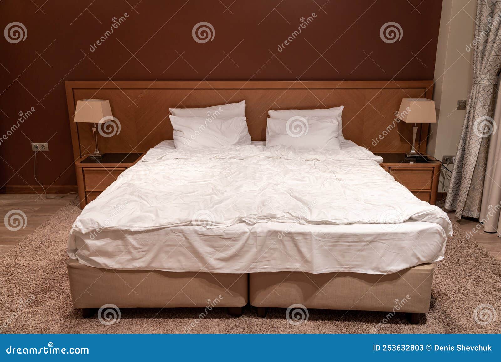 King Size Bed in Hotel Room with Bedside Tables and Lamps Stock Image