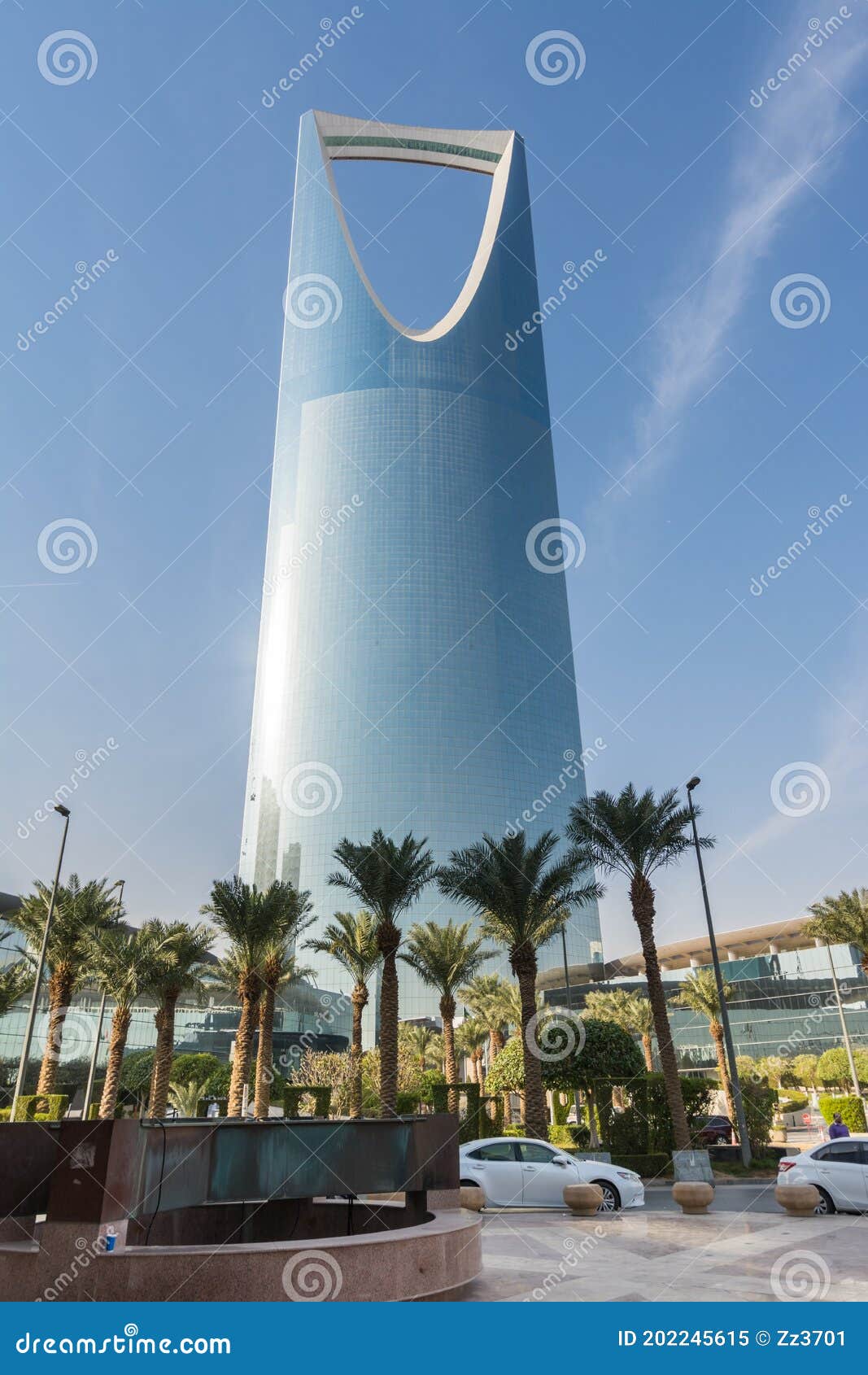 kingdom center tower or burj al mamlaka glows a blue color  again blue sky