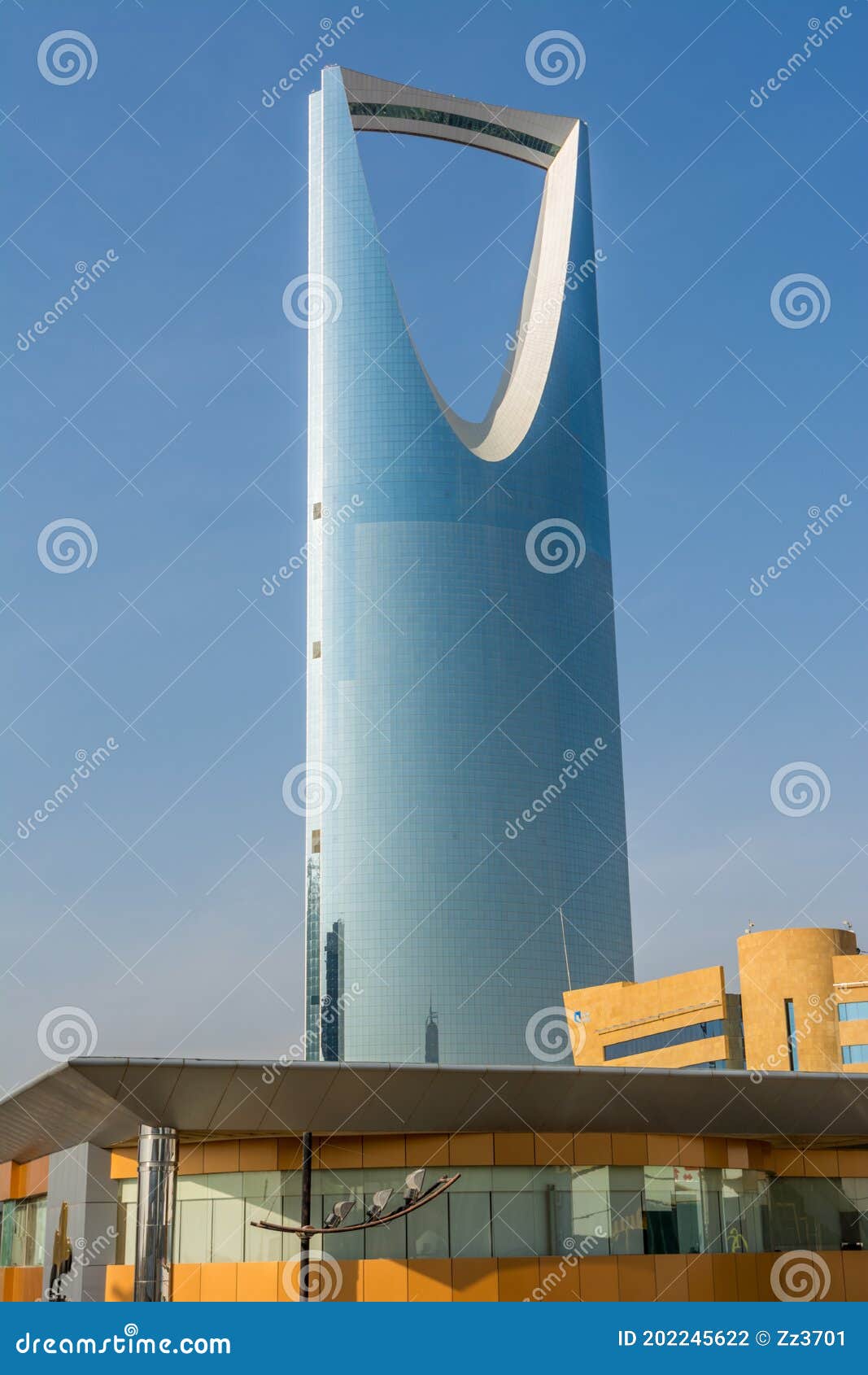 kingdom center tower or burj al mamlaka glows a blue color  again blue sky