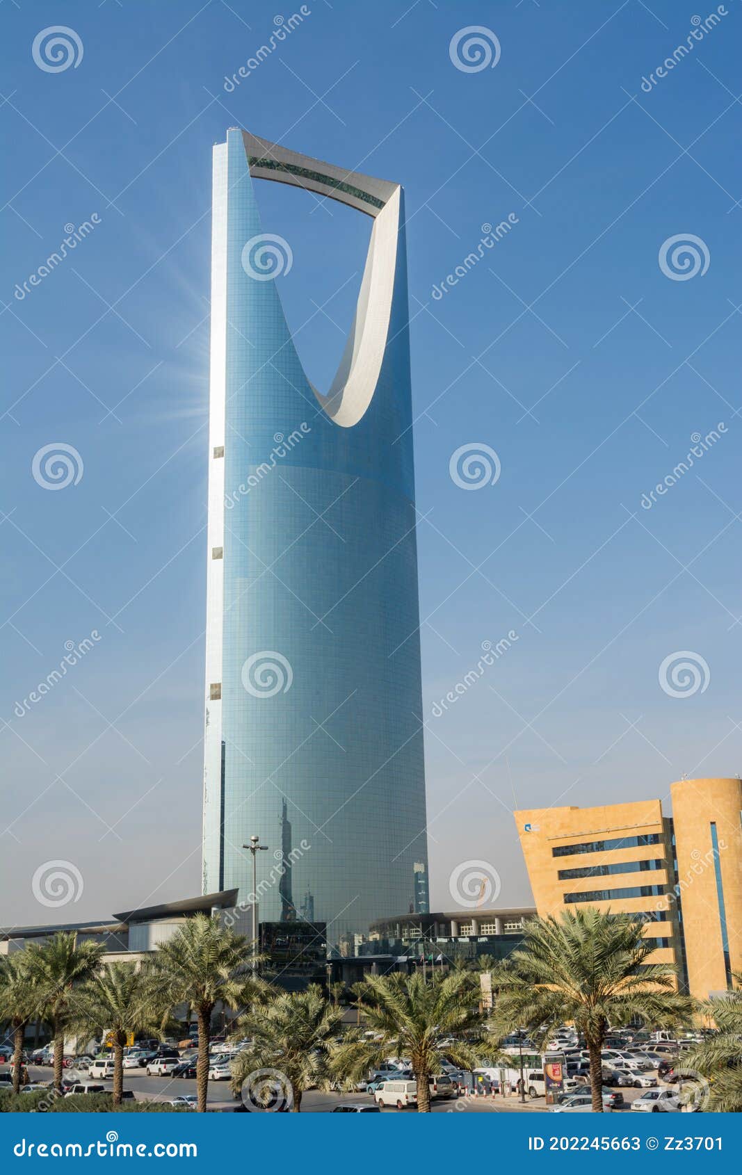 kingdom center tower or burj al mamlaka glows a blue color  again blue sky