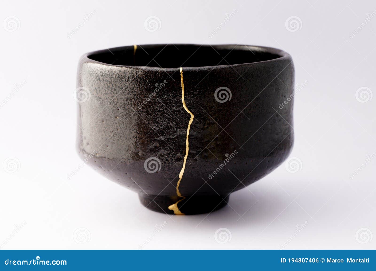 Kintsugi bowl. Gold cracks restoration on old Japanese pottery