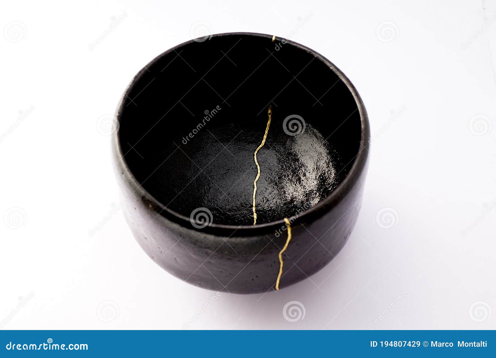 Kintsugi bowl. Gold cracks restoration on old Japanese pottery