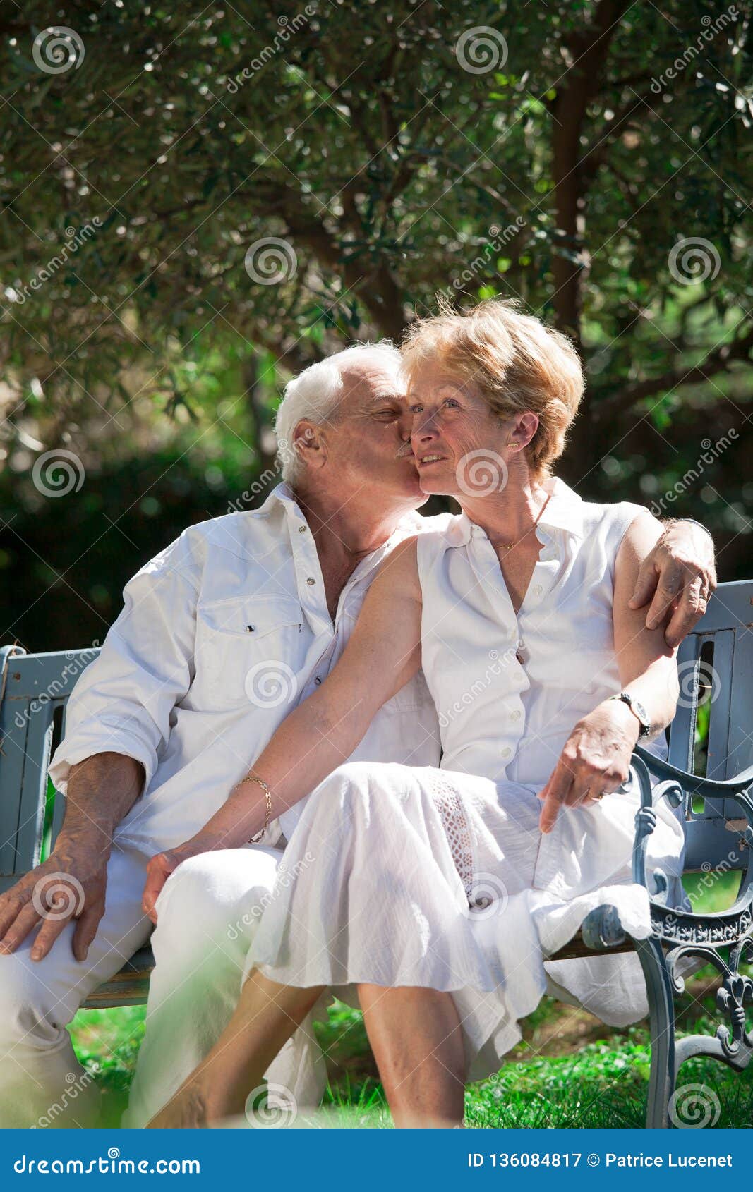 Kissing Elderly Couple In A Garden Stock Image Image Of