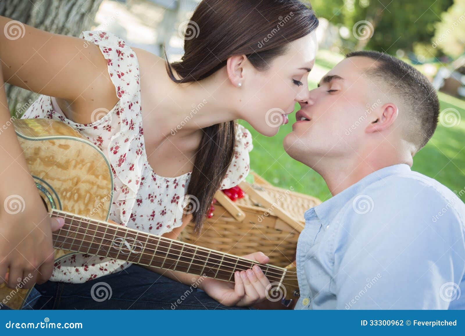 Kissing Mixed Race Couple With Guitar In The Park Stock Photo Image