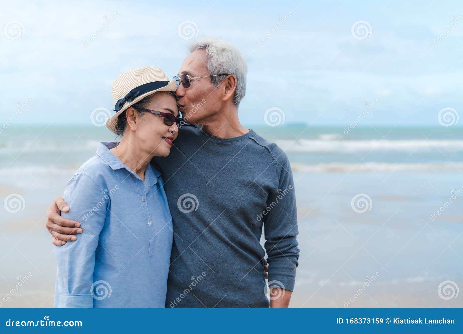 Kissing Moment Of Asian Couple Senior Elder Retirement Resting At Beach