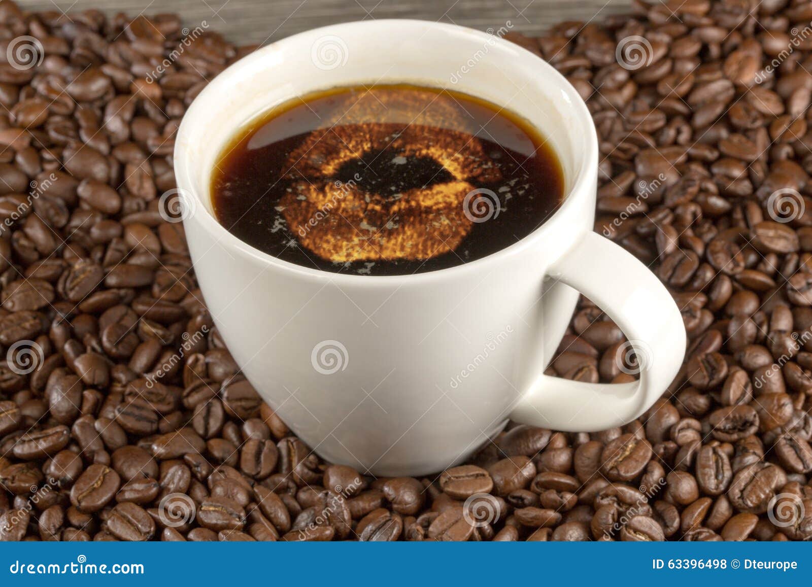 Kissing Mouth Inside a Cup of Coffee, Decorated with Beans Stock Photo