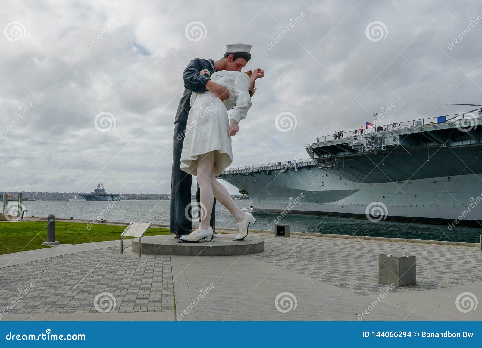 Navy guy kissing nurse