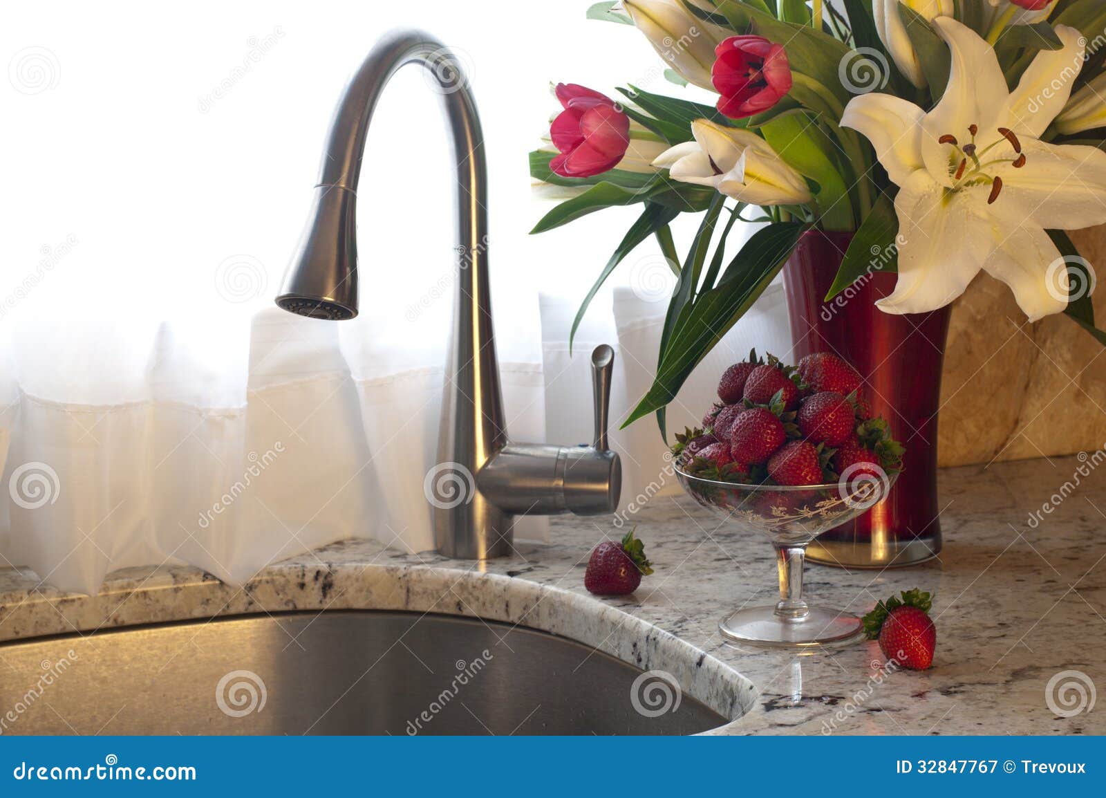 Kitchen Faucet, Strawberries and Fresh Flowers on a Counter. Stock