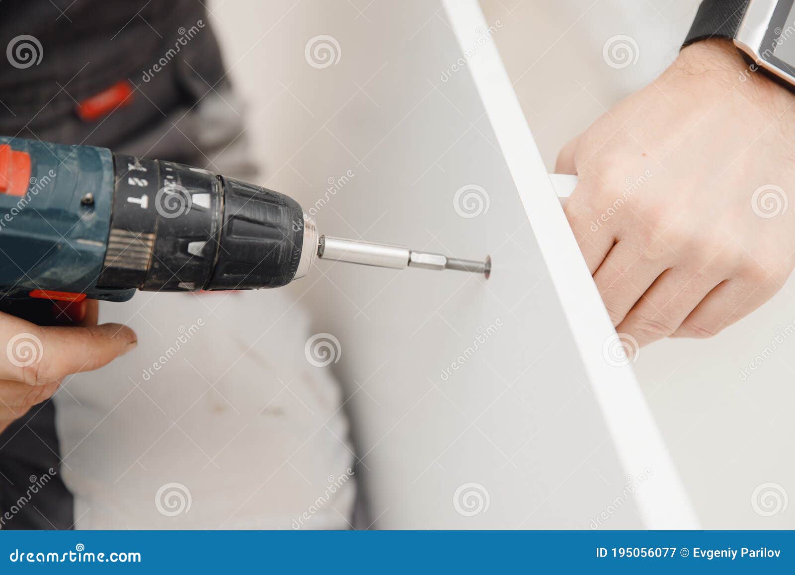 Kitchen Installation, Worker Tightens Bolts To Assemble Box from
