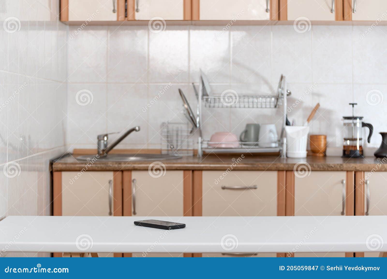 Kitchen Interior and Mobile Phone on Table. Smartphone Stock