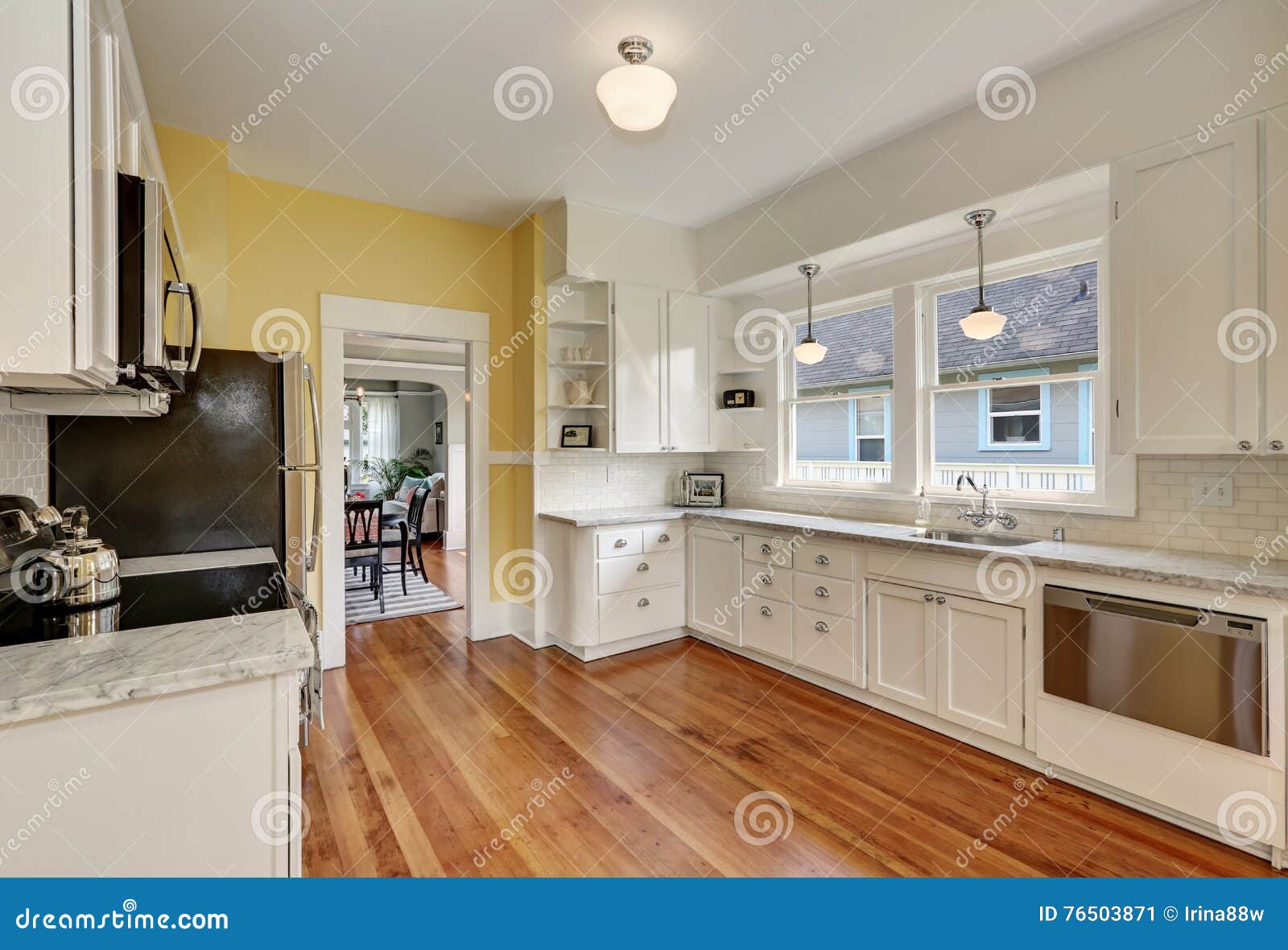 Kitchen Interior With White Cabinets Yellow Walls And Wood Floor