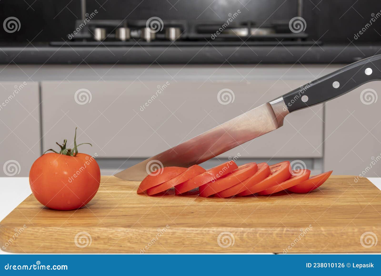 A Kitchen Knife is Stuck into a Cutting Board in the Kitchen, Sliced