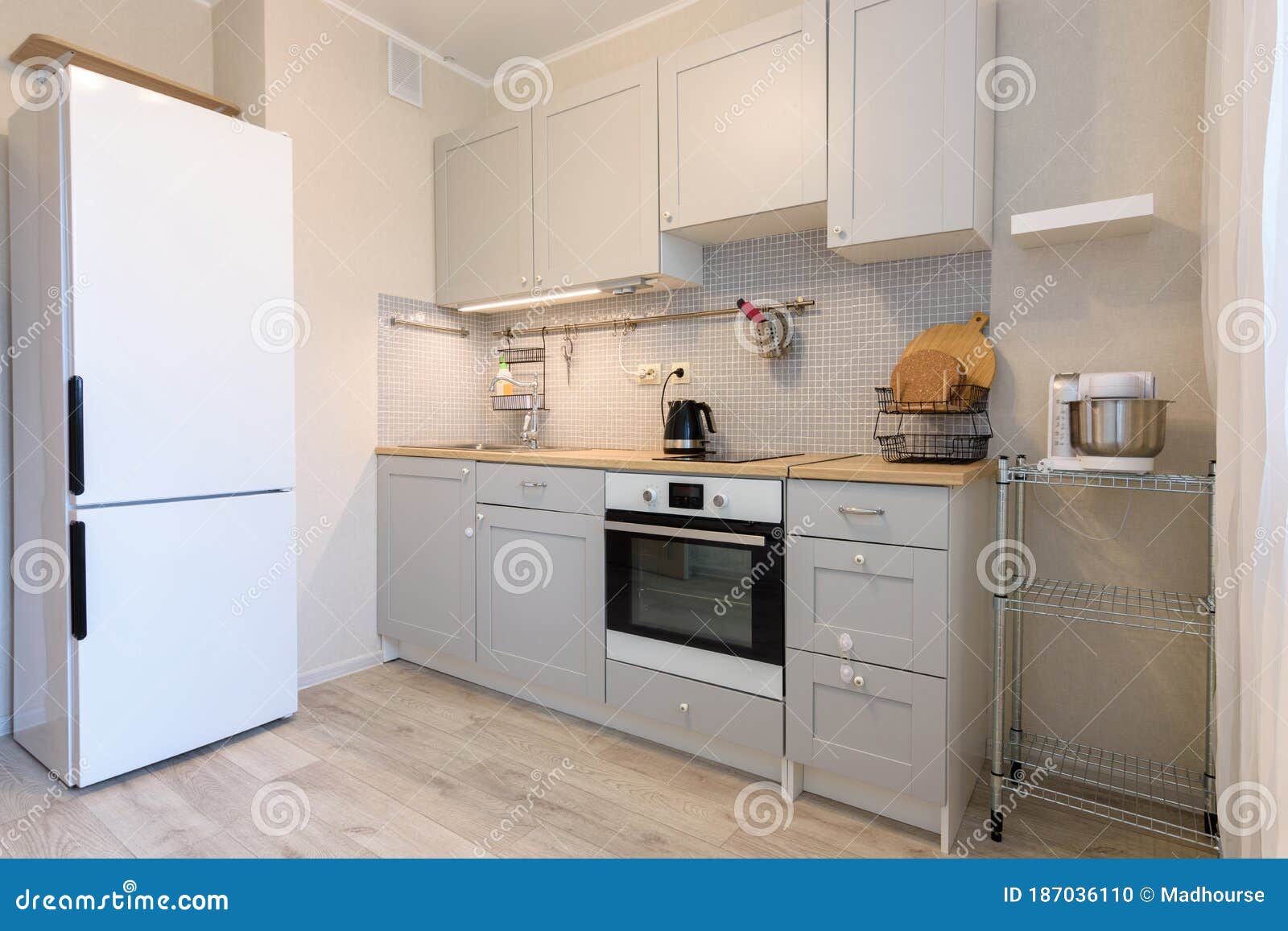 Kitchen Layout, Fridge and Direct Kitchen with Hanging Cupboards Stock