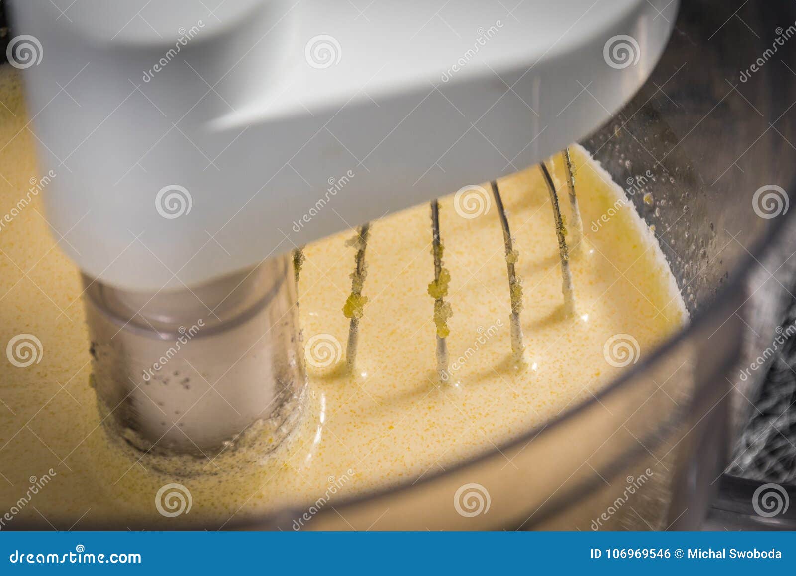 A Kitchen Mixer with Yellow Egg Yolks Mixed with Sugar in a Mode Stock