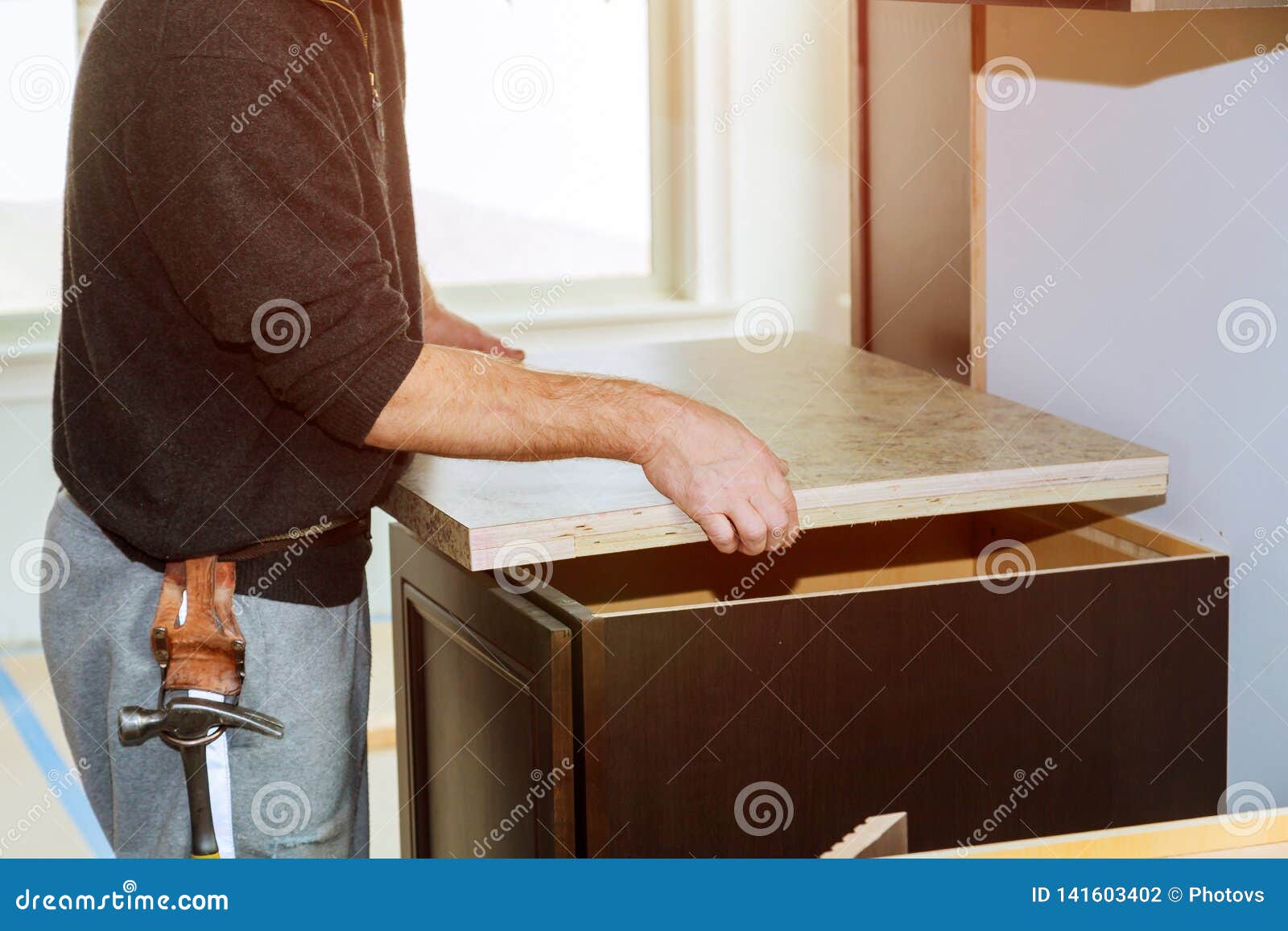 Contractor Installing A New Laminate Kitchen Counter Top Stock