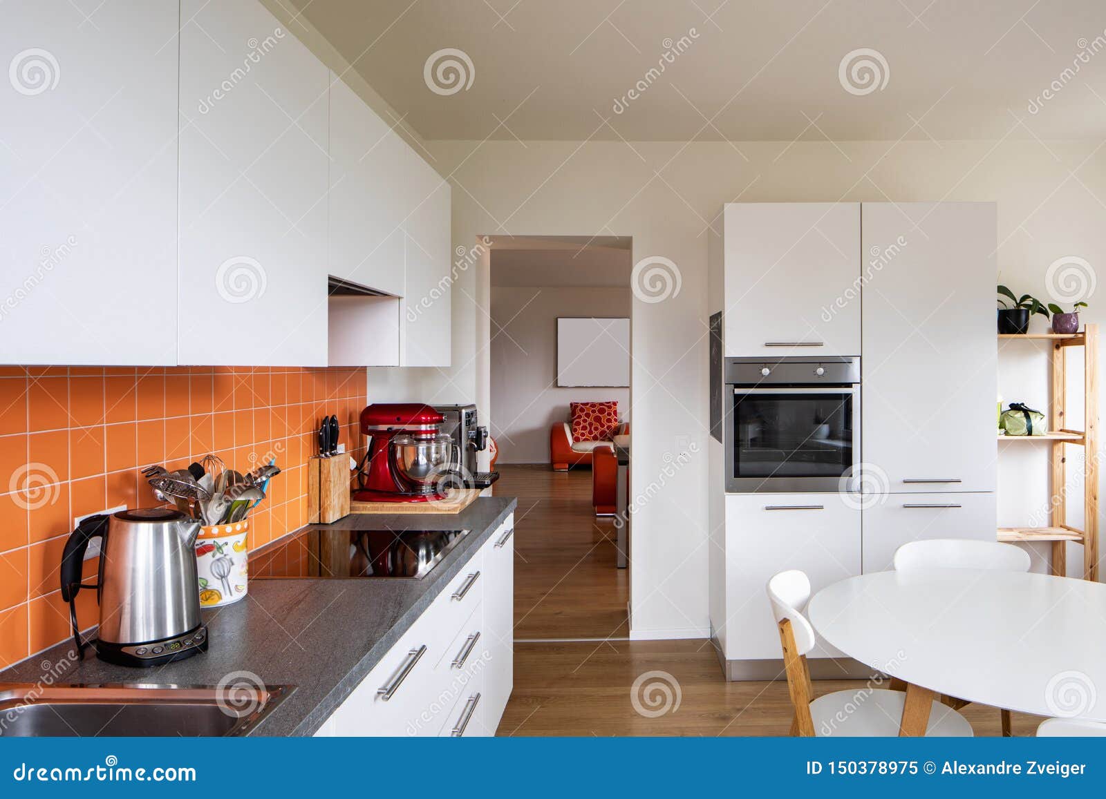 Kitchen with Orange Tiles and a Modern Table. Large Window with a View
