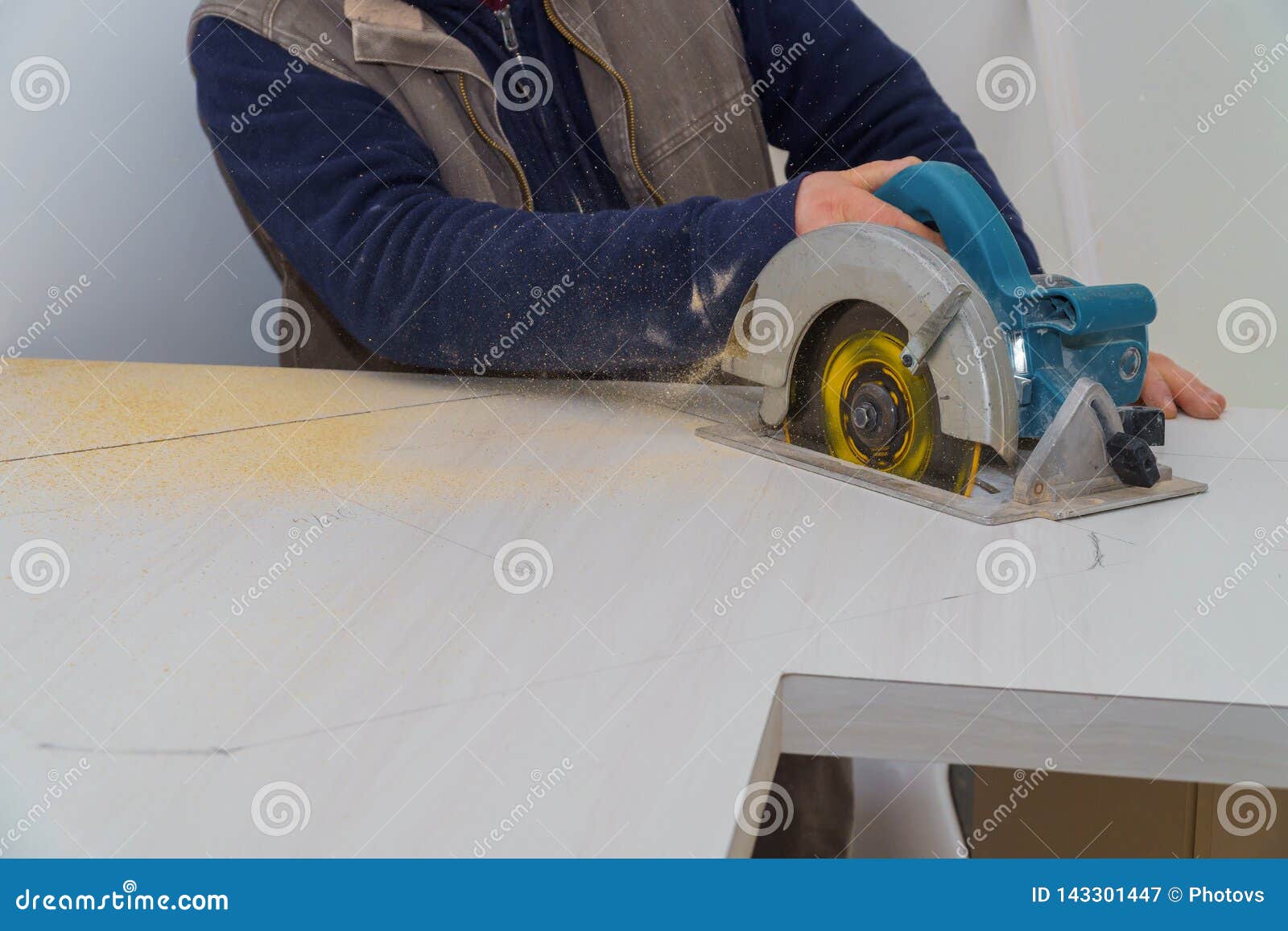 Contractor Using Electric Saw To Cut Through A Laminate Kitchen