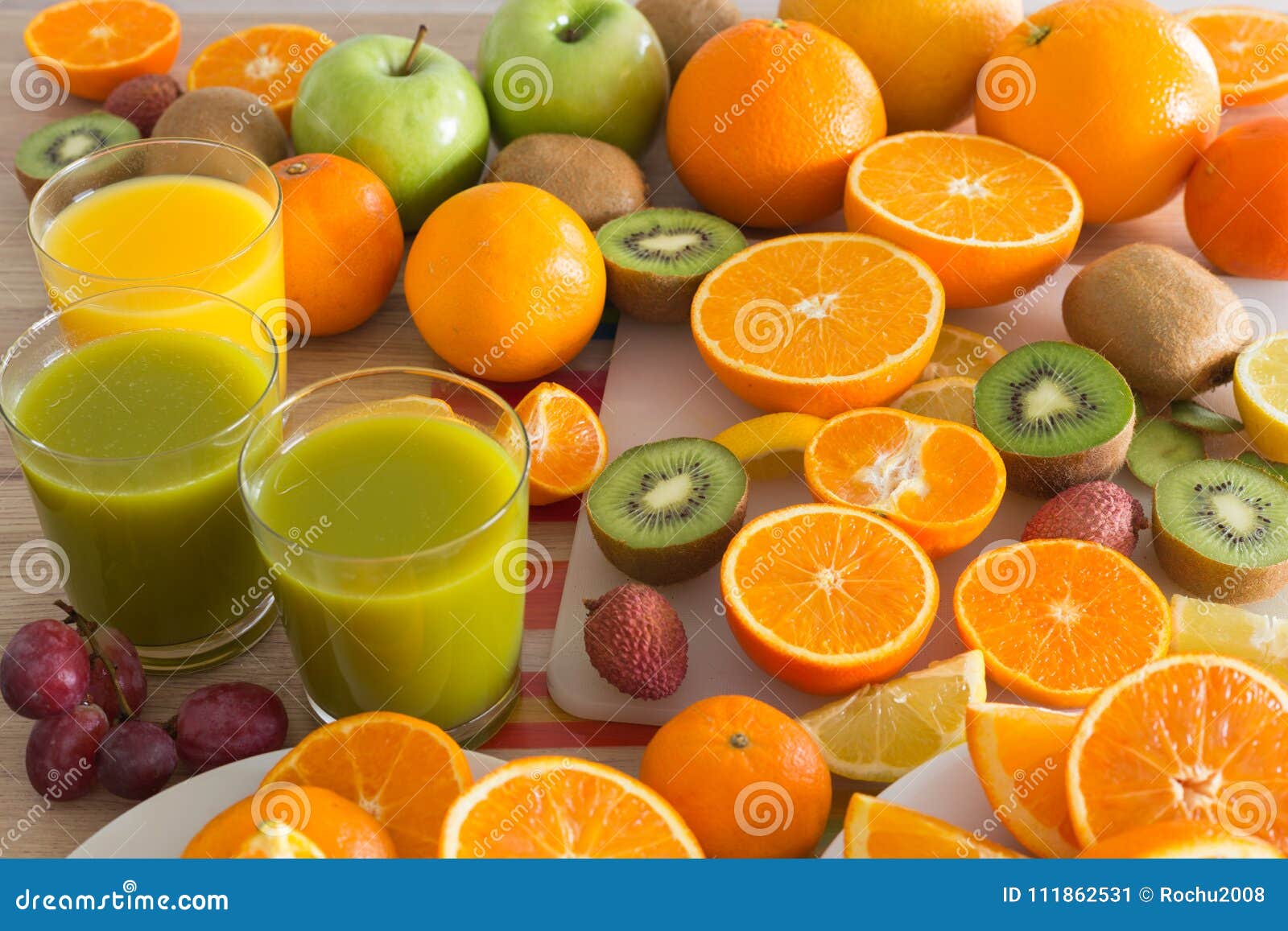 Kitchen Table Set with Various Types of Fruit and Juices. Stock Image