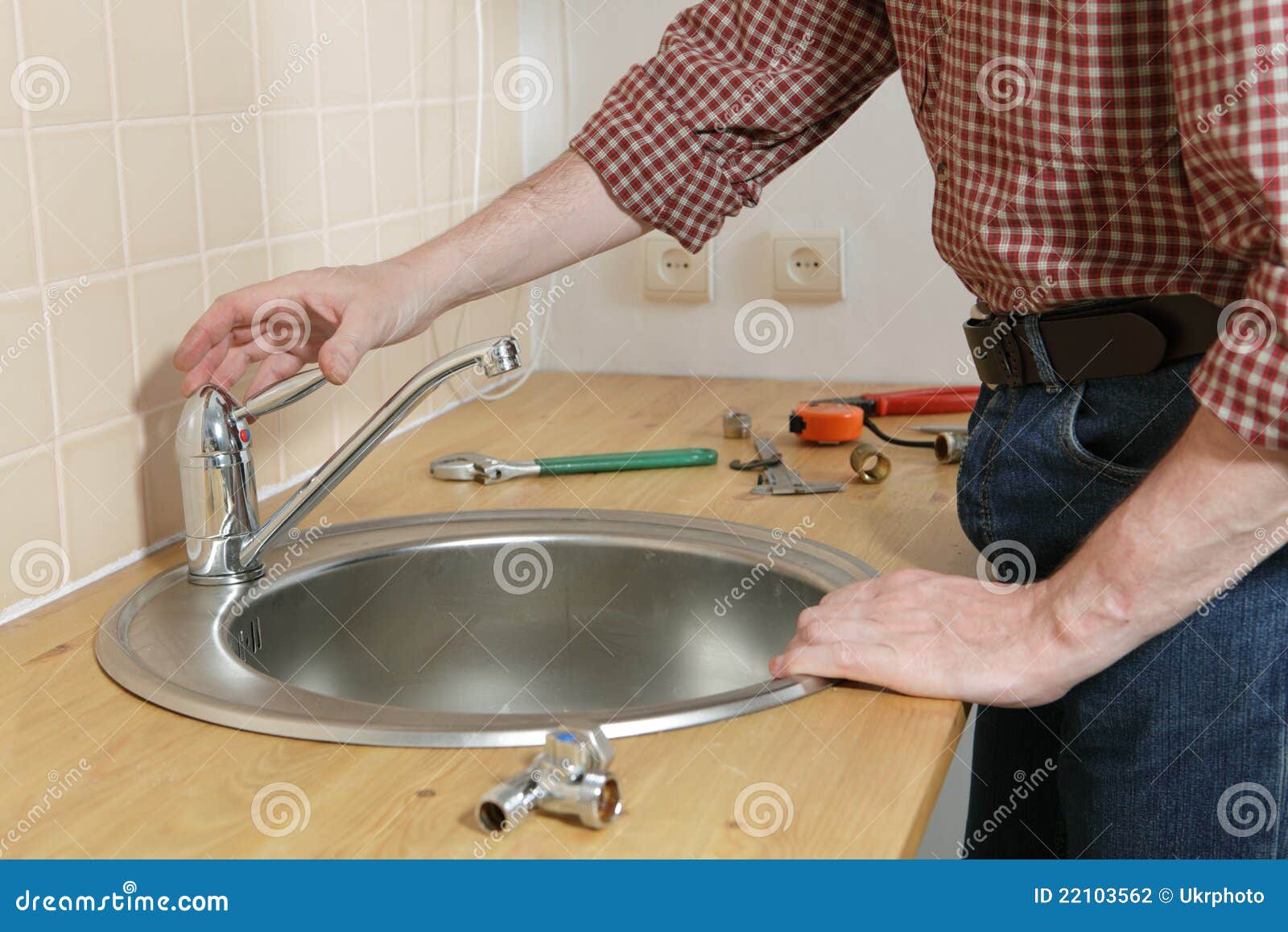 Kitchen tap installation stock photo. Image of working 22103562