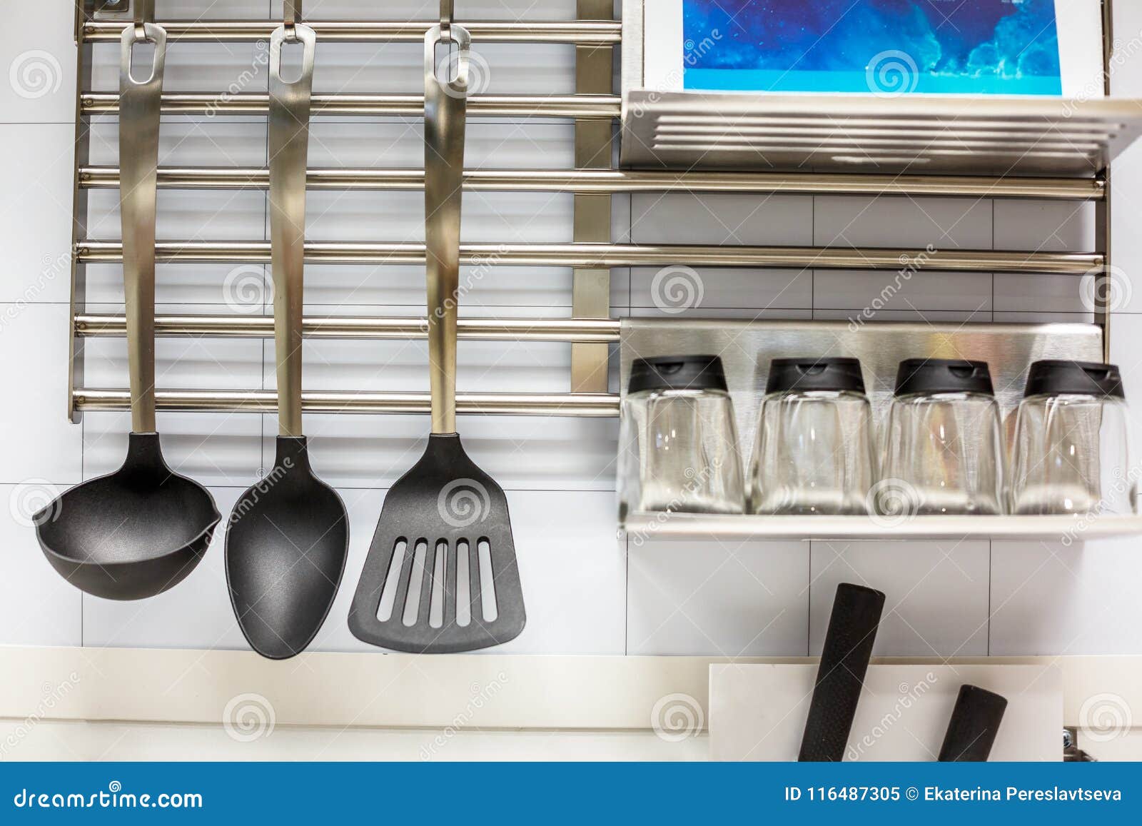 Kitchen Utensils Hanging on White Wall the Wall in the Working Area