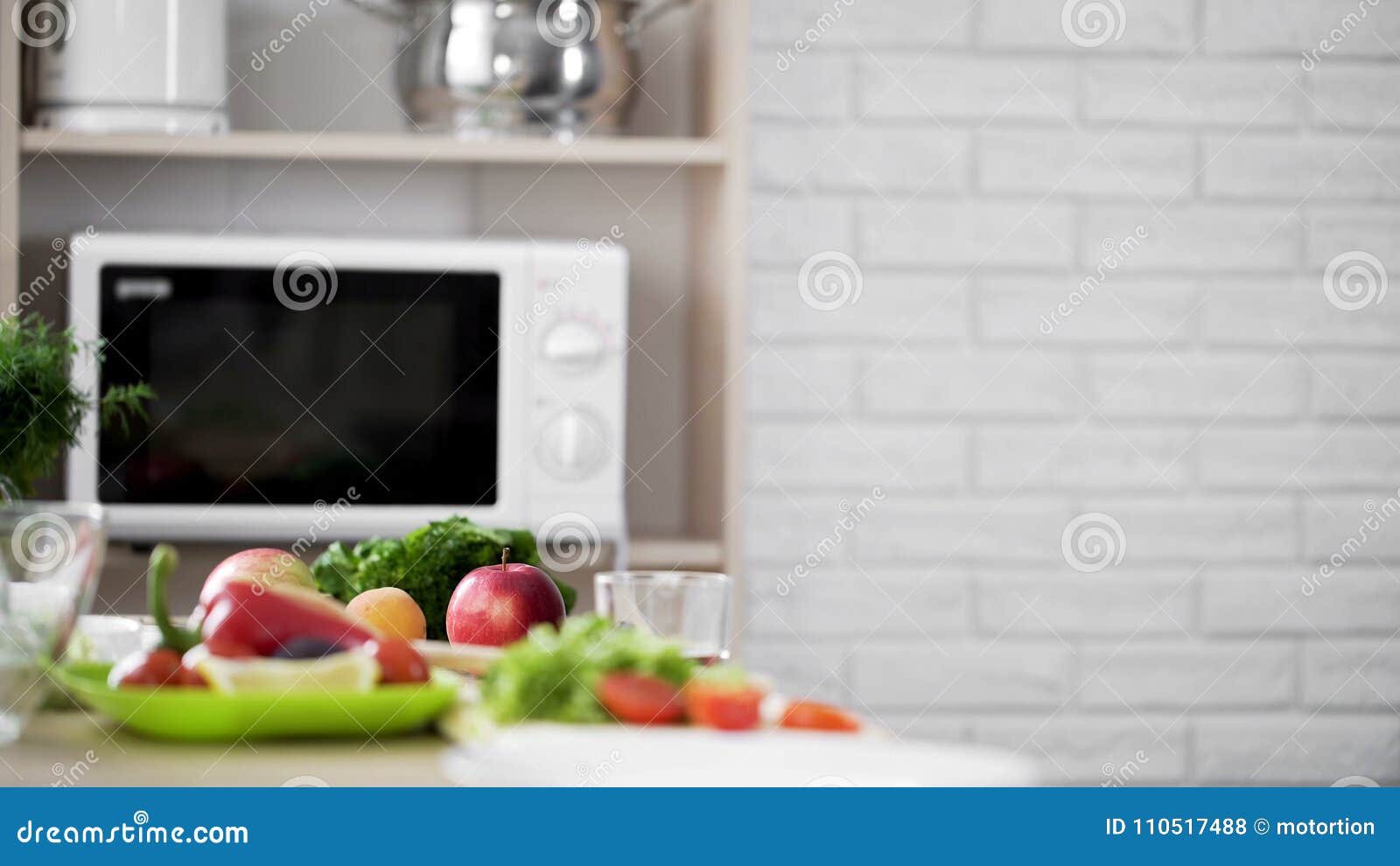 Kitchen View with Microwave Oven and Fresh Vegetables and Fruit on the