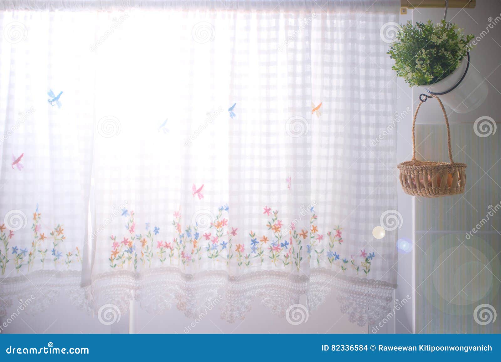 Kitchen Windows Dressed with Lace Curtain and Flower Pot Stock
