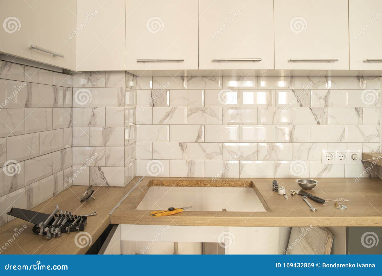 Kitchen With Wooden Worktop White Cabinets And White Metro Tile