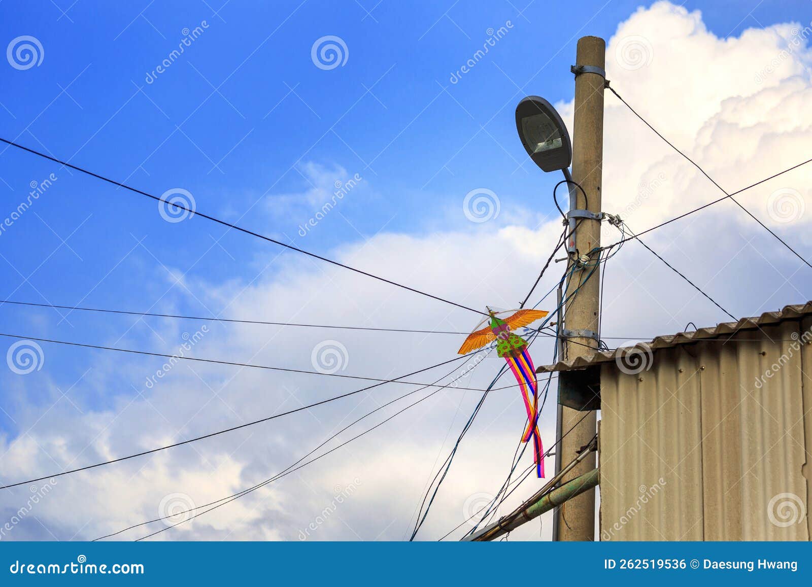 A Kite Caught in an Electric Wire Stock Photo Image of communications