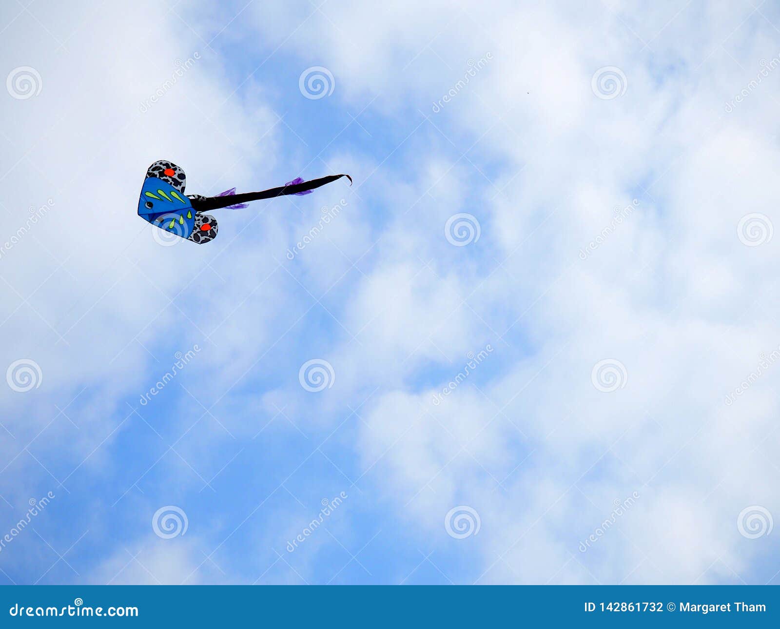 A kite flying in the sky. stock photo. Image of blue 142861732