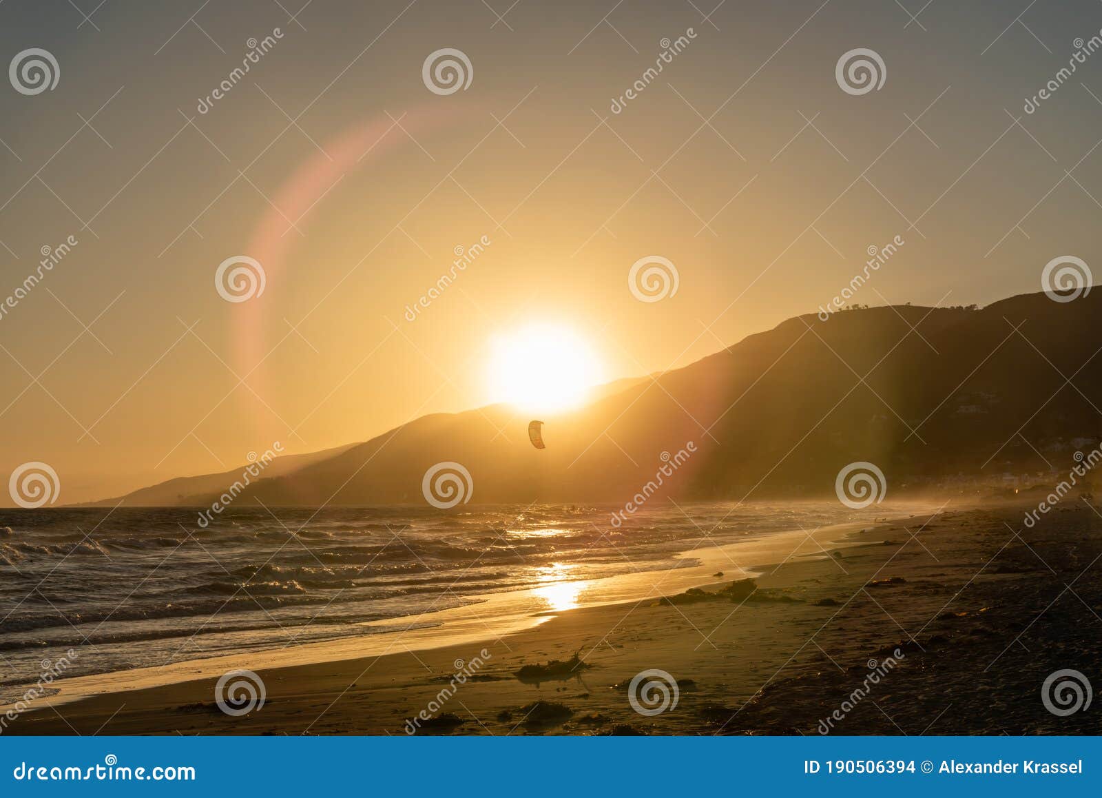 kite surfing at sunset at zuma beach, malibu, california