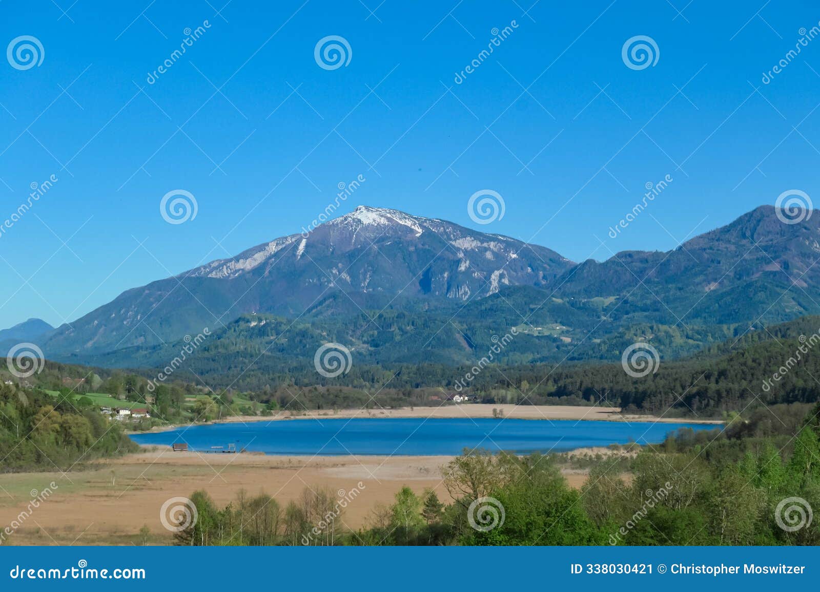 klopein - breathtaking aerial view of a tranquil lake turnersee nestled amidst lush green forest and karawanks mountain range