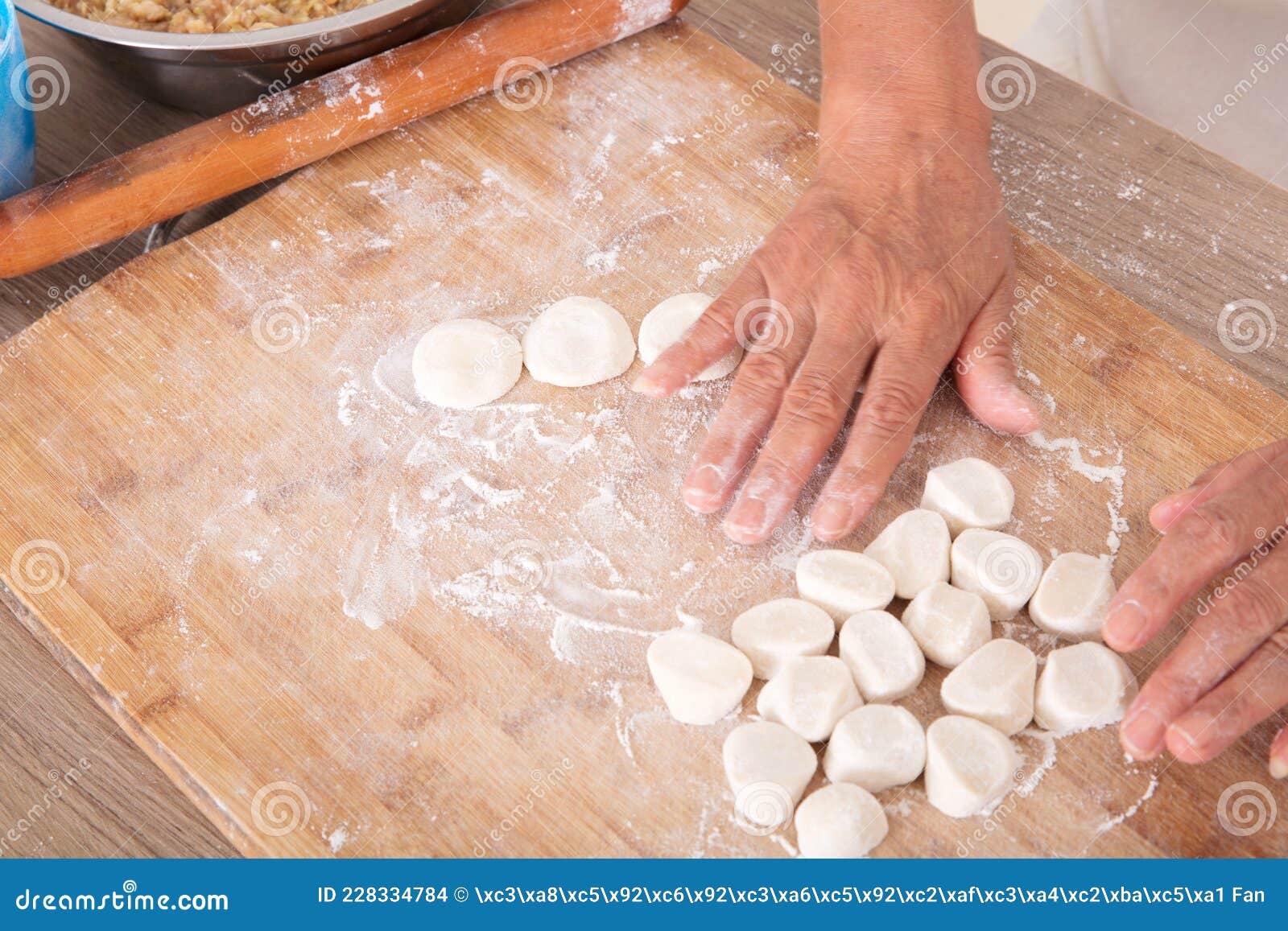 Knead the Floured White Dough on the Cutting Board with Both Hands