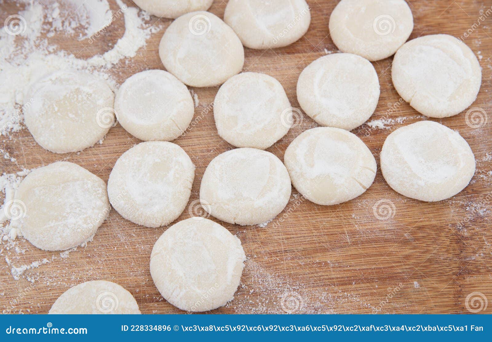 Knead the Floured White Dough on the Cutting Board with Both Hands