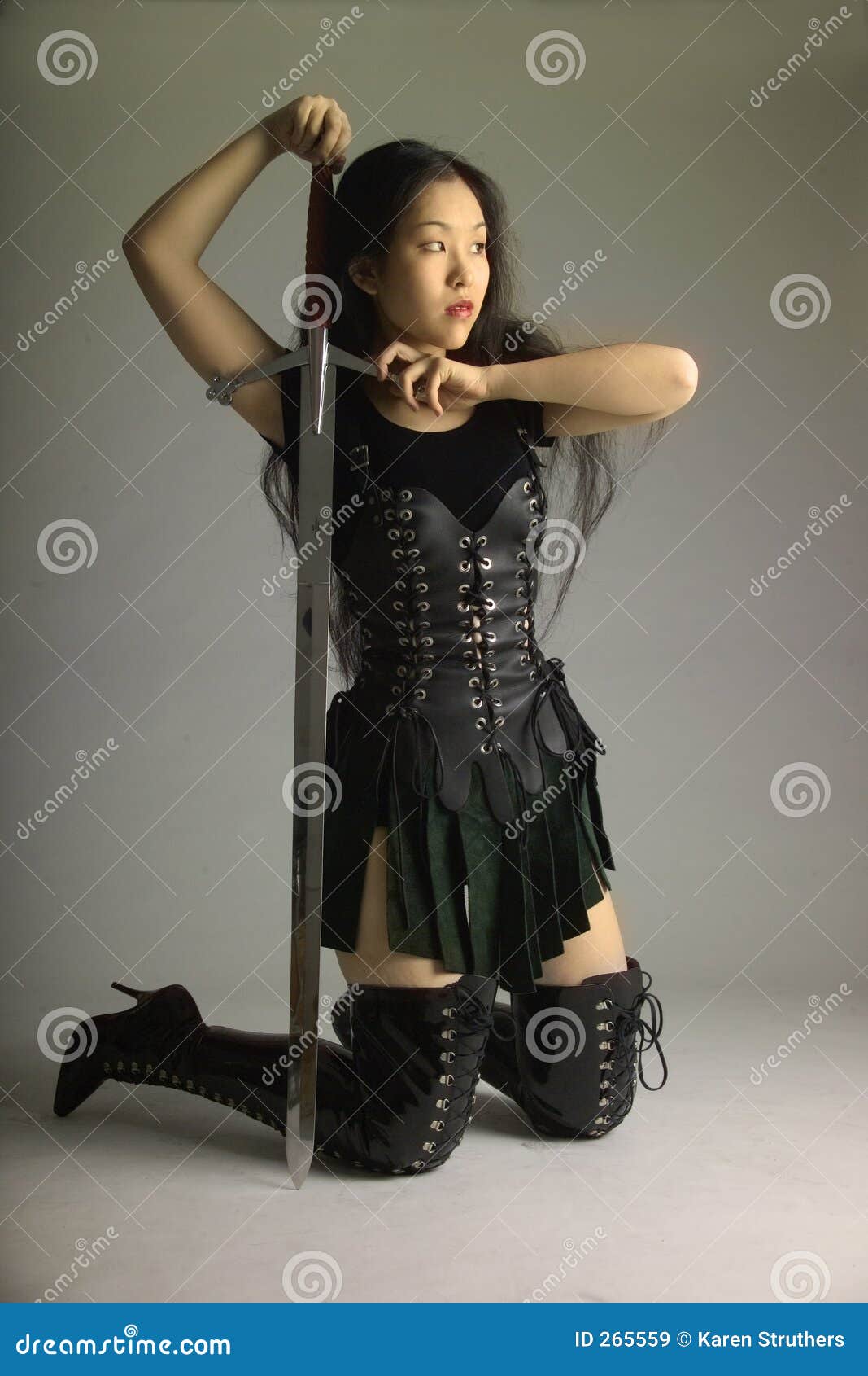 Kneeling Warrior Princess With A Sword Royalty Free Stock Images