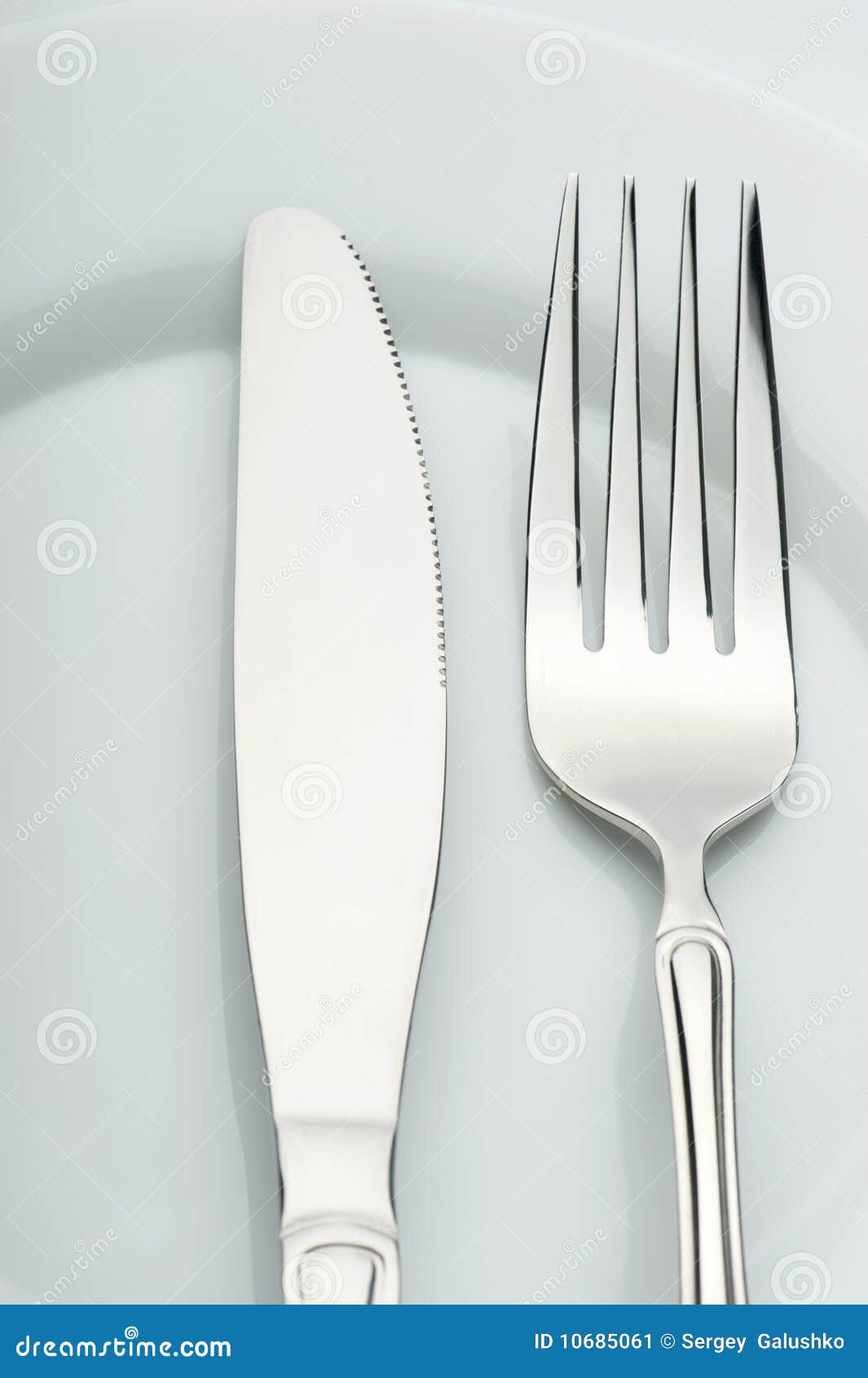 Knife and fork on a plate stock image. Image of food 10685061