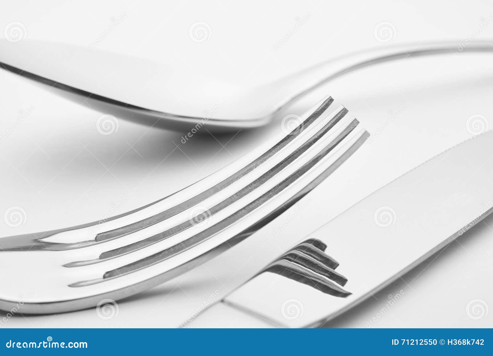 Knife Fork Spoon Detail Over a White Background. Cutlery Stock Photo